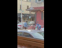 Justin Glaze Leans Over Fire Hydrant as he Poses