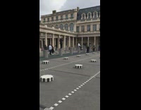 people sitting on black white pillars