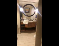 Guy reaches out of shower to get white towel and drops glass