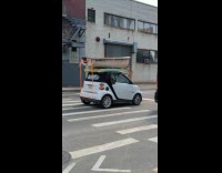 Tiny car transport boat on the road