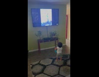 Boy watch daily dose of internet videos on television 