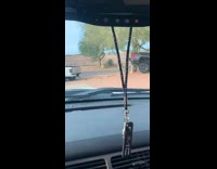 White truck tows stuck grey truck dirt