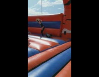 Little boy jumps on red blue bounce house jumper and scorpions
