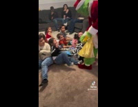 Person in Grinch Costume Takes Presents from Kids