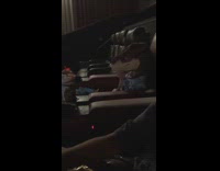 Girl wears Dinosaur mask inside the cinema