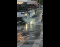 Sparks fly under street while traffic drive over it 