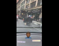 Biker rides motorcycle with TV in his arms 