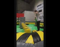 Girl plays Meltdown obstacle course and gets knocked down by spinning arms