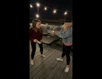 Two women struggle to figure out how to shotgun alcohol