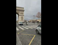 Two women stand road Arc de Triomphe