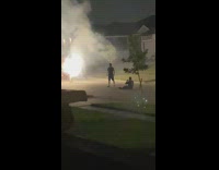 Black shirt guy neighborhood street firework sparkler
