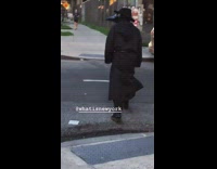 Black bird mask trench coat guy sidewalk