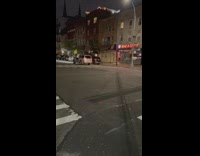 Man holds onto side of a moving car