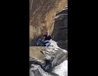 Bald guy black shirt waterfall selfie 