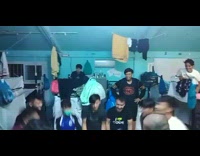 Guys fling guy on blanket up against roof 