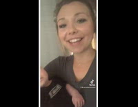 Girl holding baby and it throws up in her arms 