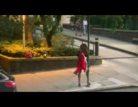 Woman black dress pose beside pole for pictures