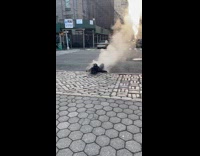 Man lays on top of steamy man hole