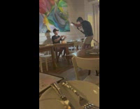 Man holds his food for a photo inside the restaurant