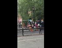 Lady pedals on calisthenics machine at park 
