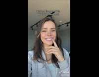 Girl in grey zip up jacket laughing