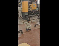 Little boy at gym using two pull devices jumping between them