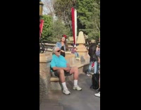 Pt. 2 Girl with Minnie Mouse ears sits in front of Disneyland castle and takes a picture