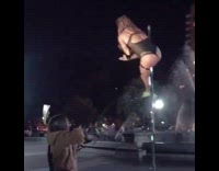 Girl throws cash at pole dancer at park 