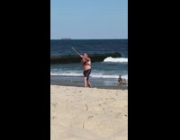 Old man shirtless wooden stick exercise beach