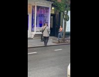 Man wear headphones grey jacket dance on street