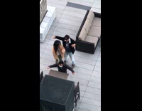 Three people tiktok dance rooftop deck building