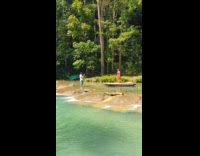Woman pink dress dances on the raft