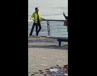 Guy shades yellow long sleeves railings ocean