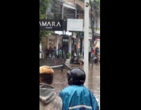 Woman green dress poses in the flood