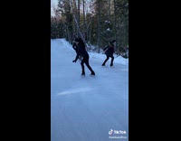 Three ice skaters doing spins together in sync 