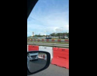 Car flipped upside down side of highway