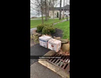 Case of Titos liquor bottles outside