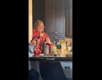 SUBMITTED FIRST TO BITCH - Woman popping up cork on wine bottle
