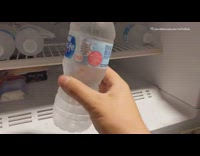 Guy shakes bottle water freezes into ice
