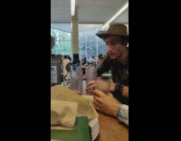 Two men spins and blow cups to shoot in another cup