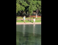 Little girl red hat dances at park