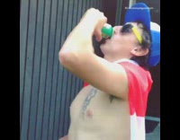 Drunk guy wearing Canadian flag drinks green beer can, jumps off ledge on bike and crashes into the ground