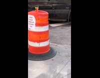 Orange traffic cone with sign about honks