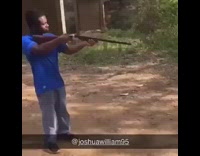 Guy in blue shirt shoots shotguns, gun recoils and flies in the air straight