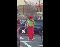 Clown juggles pins performs during stop light