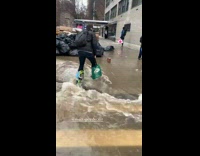 Guy wears reusable bags as shoes rain 