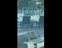 Two girls take photos at closed pool