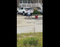 White shirt guy vacuums street road driveway 