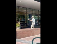 Collab WINY - Man dance in front of band outside building