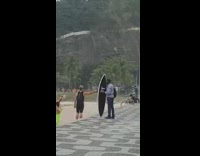 Collab Kook Of The Day - Black wetsuit guy poses surfboard beach sand 